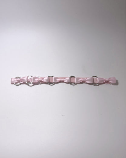 Runaway Pink Bow Belt on softly lit surface