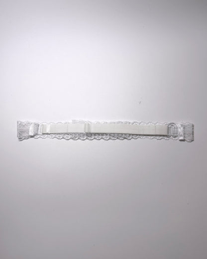 Siren White Lace Bow Bridal Belt on light gray surface back view