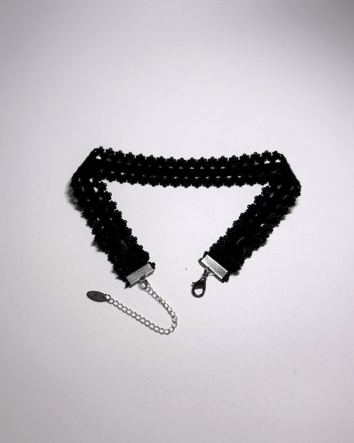 Black Elastic bow choker on light gray background showing bows and extender chain