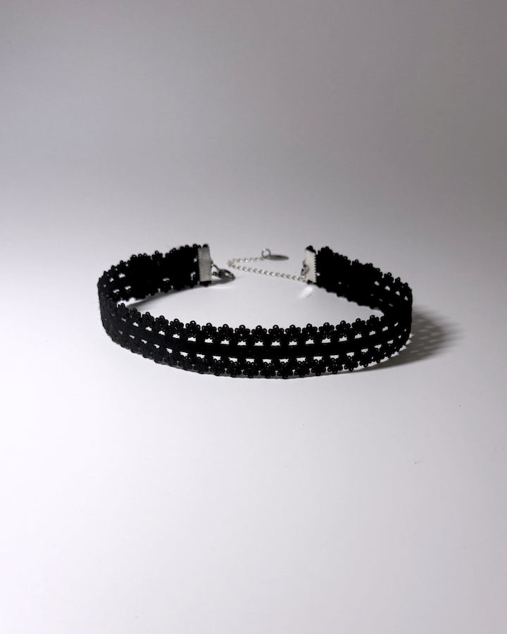 Black Elastic bow choker on light gray background