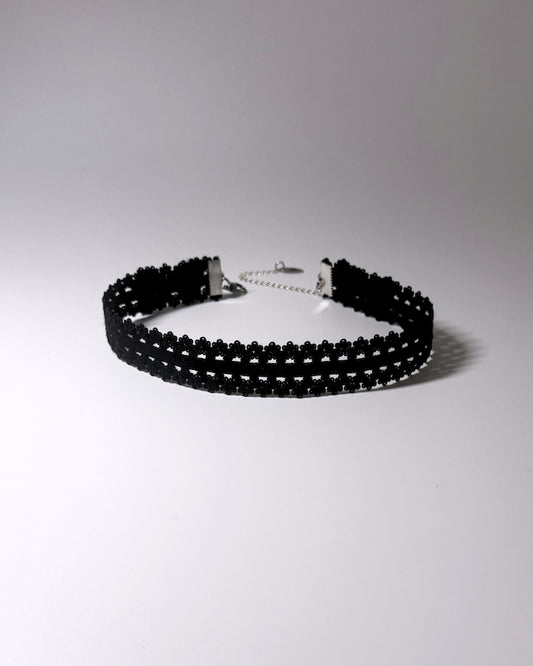 Black Elastic bow choker on light gray background