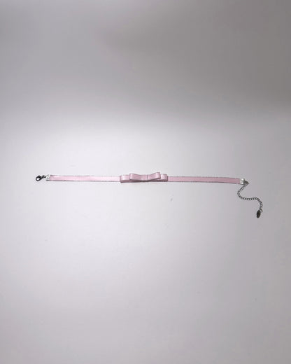 Pink Metallic Silver Bow Choker displayed flat showing lobster clasp and extender chain