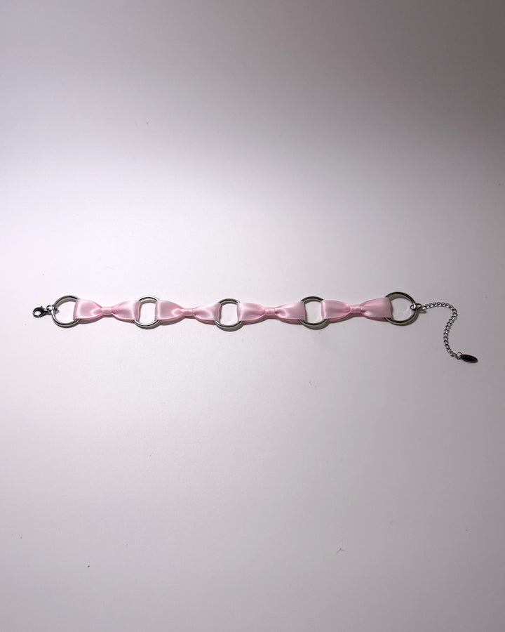 Runaway Pink Bow Choker on softly lit background