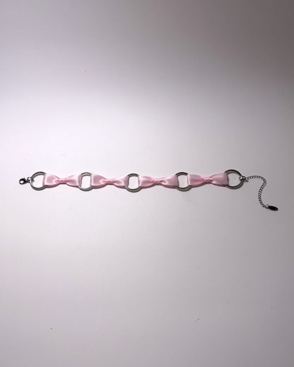 Runaway Pink Bow Choker on softly lit background