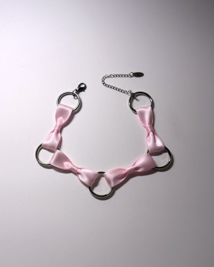 Runaway Pink Bow Choker with O Rings on softly lit background