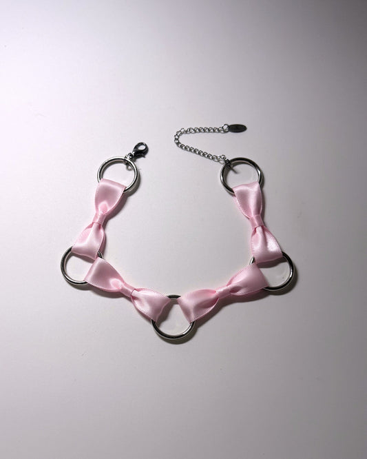 Runaway Pink Bow Choker with O Rings on softly lit background