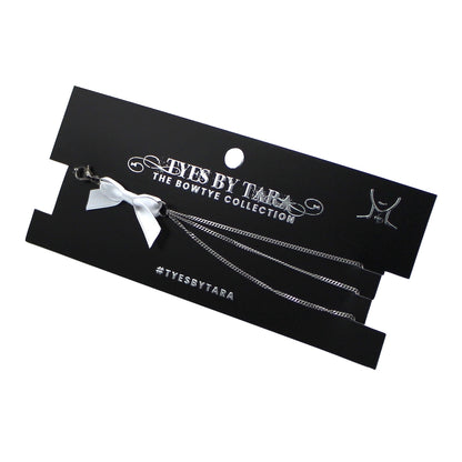 vice white bow silver chain necklace on black card