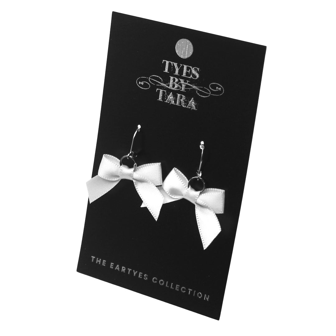 Honey White Bow Earrings with Leverback Earwires on Black Card