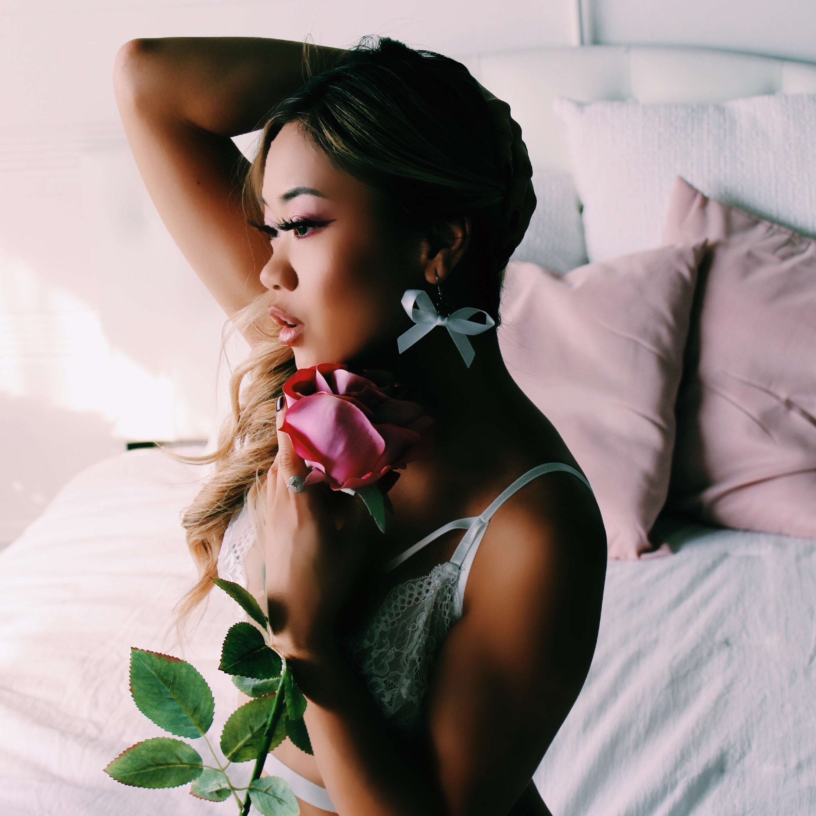 White XO Bow Earrings on Model with Rose