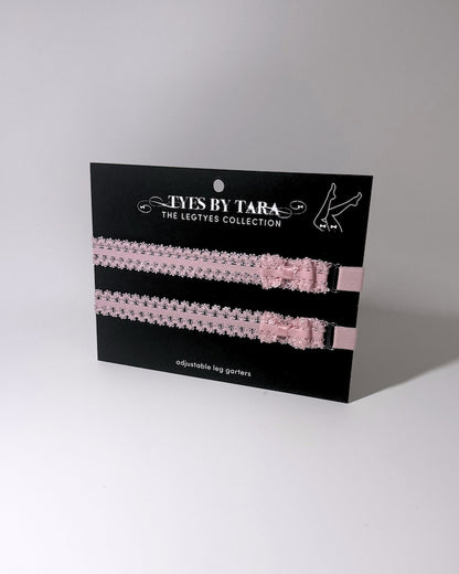 Lady Pink Elastic Leg Garters with soft adjustable straps on gray background on black card