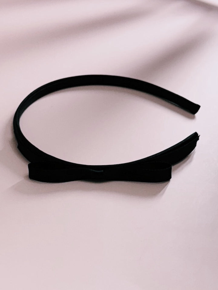 Enchantress Black Bow Headband on Pink Background