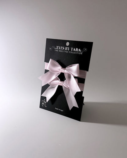 packaging view of pink bow heel straps