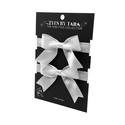 White Bombshell Bow Heel Straps on Black Card