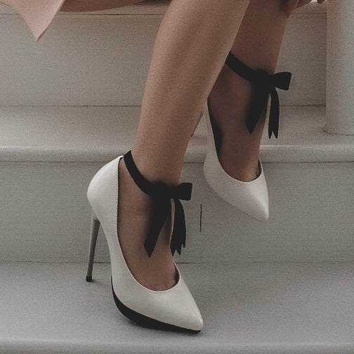 Model in White Heels and Doll Black Bow Heel Straps