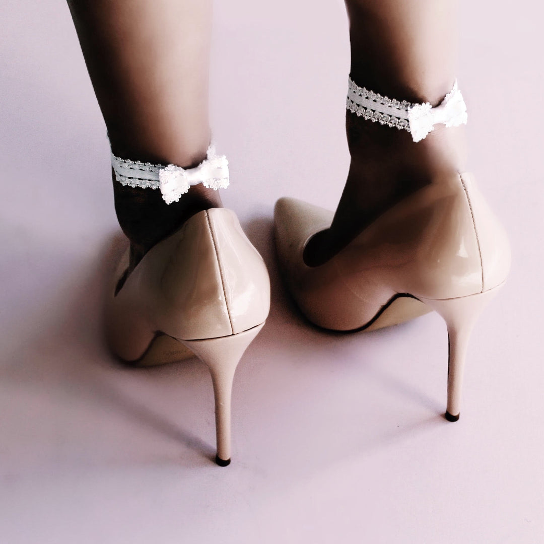 White Heel Straps on Model with Pink Background