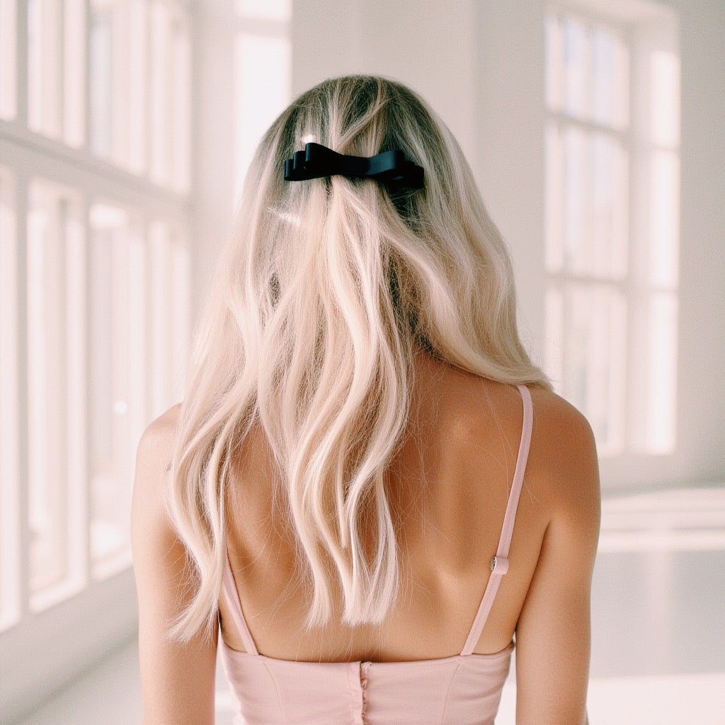 Highness Black Bow Hair Barrette on Blonde Model in Pink Dress