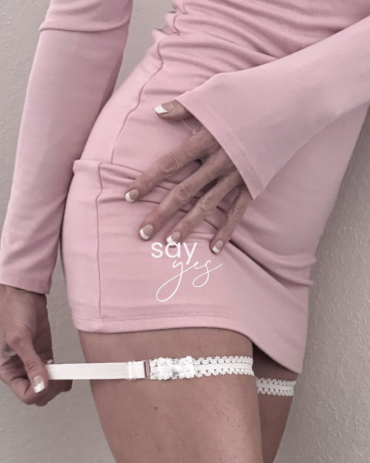 lady white bow leg garters on model in pink dress