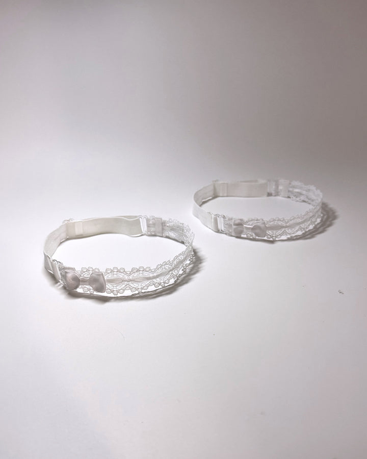 Chantilly White Lace Bow Leg Garters showing adjustable straps on light gray background