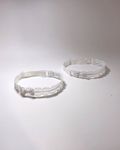 Chantilly White Lace Bow Leg Garters showing adjustable straps on light gray background