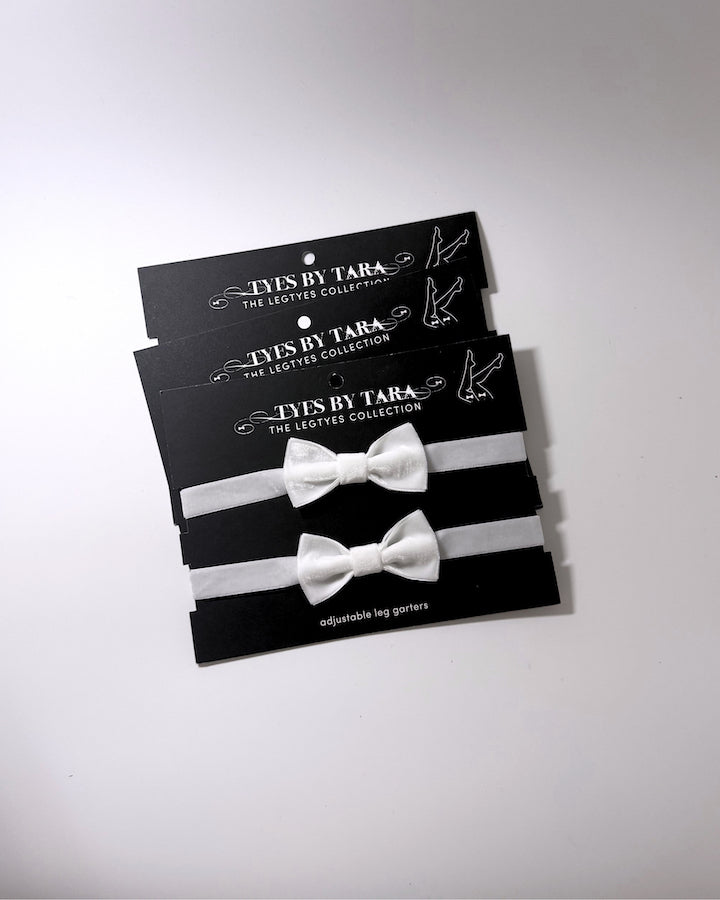 madam white velvet bow leg garters shown in a 3 pack