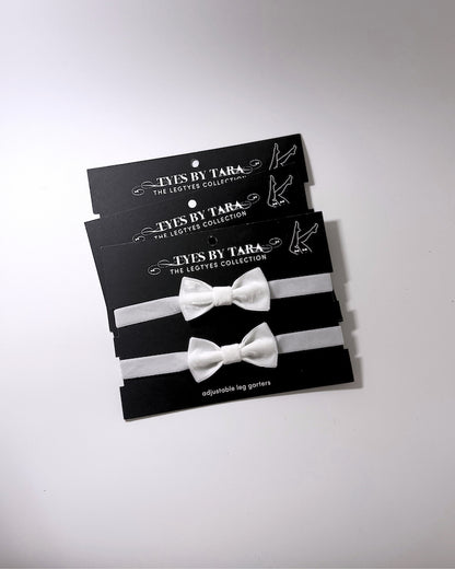 madam white velvet bow leg garters shown in a 3 pack