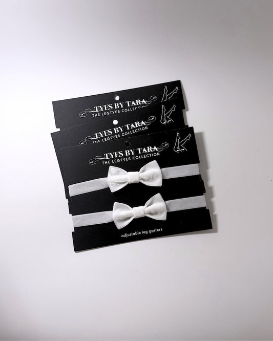 madam white velvet bow leg garters shown in a 3 pack