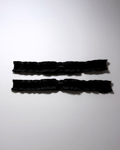 Maiden Black Ruffled Leg Garters with Bows placed vertically next to each other