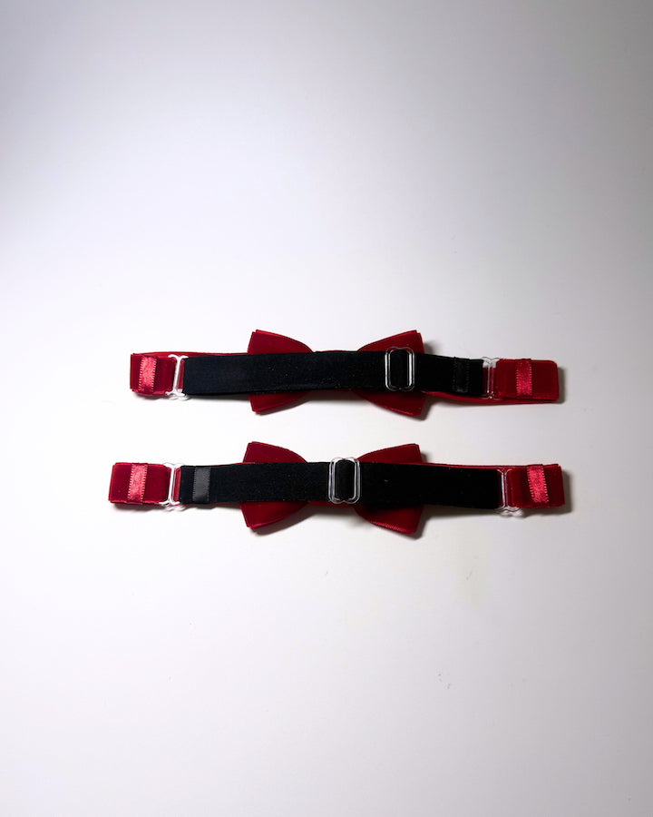 back adjustable strap view of the Red velvet leg garters on a softly lit surface