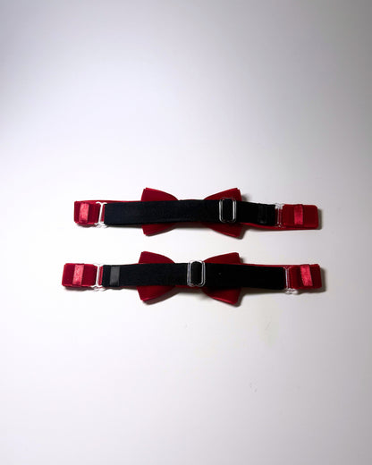 back adjustable strap view of the Red velvet leg garters on a softly lit surface