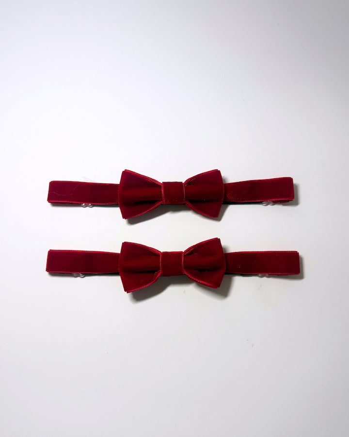 Red velvet leg garters on a softly lit surface