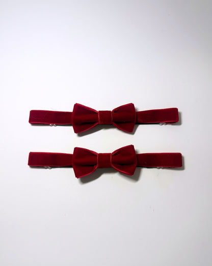 Red velvet leg garters on a softly lit surface