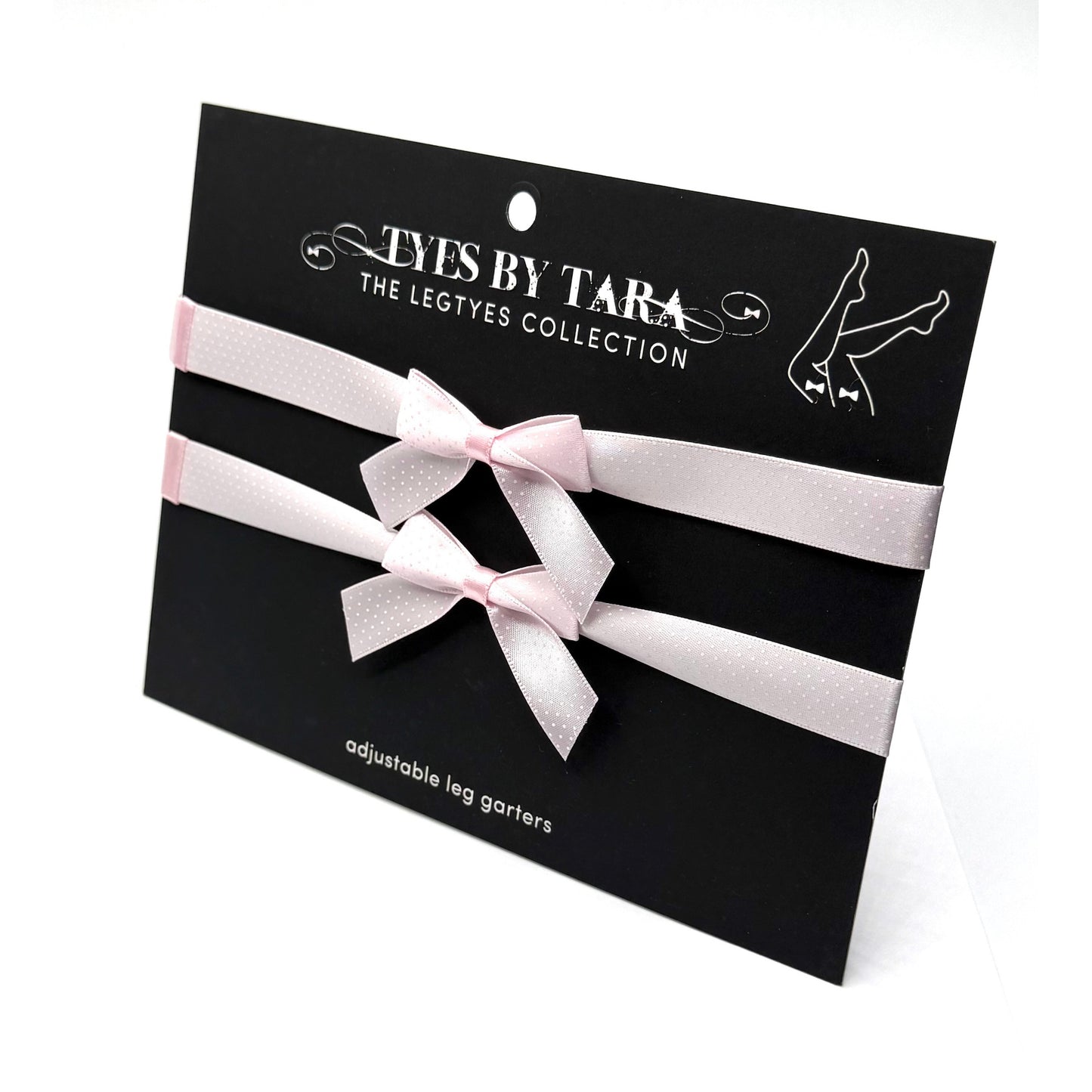 Pinup pink bow leg garters on black card