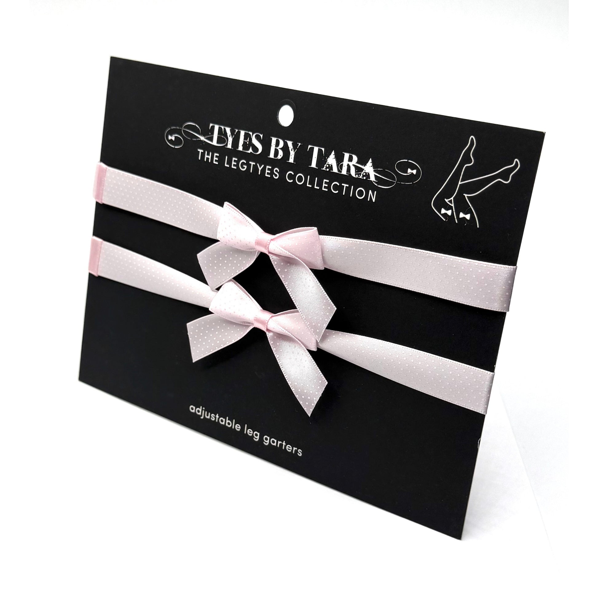 Pinup pink bow leg garters on black card