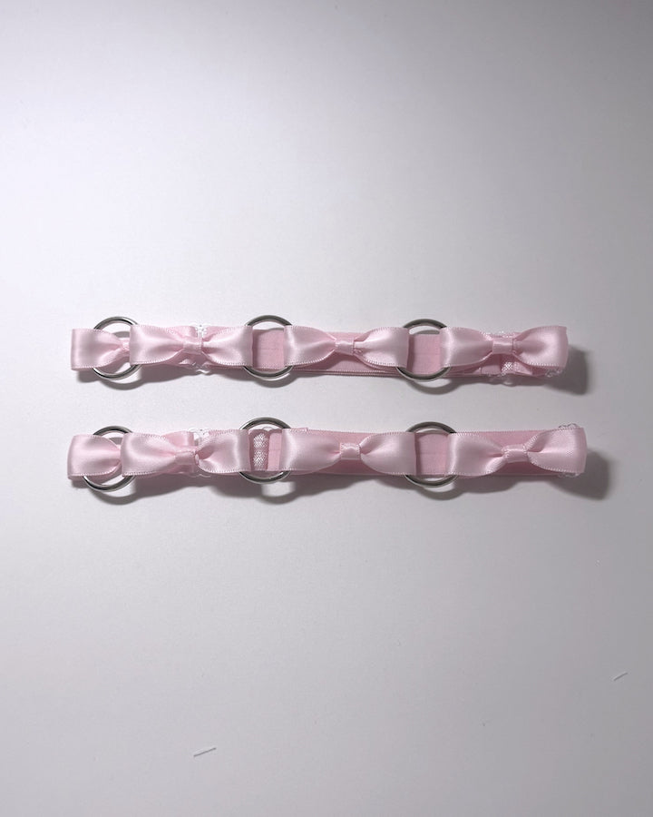 Pink Runaway O Ring Leg Garters on softly lit background