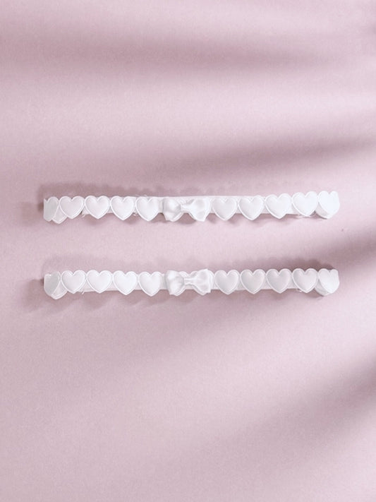 White Heart Leg Garters On Pink Background