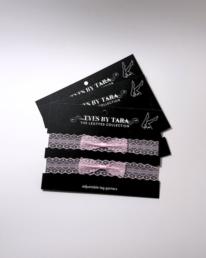 Siren Pink Lace Leg Garters on black cards shown as a 3 pack
