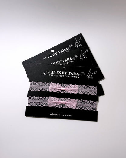 Siren Pink Lace Leg Garters on black cards shown as a 3 pack