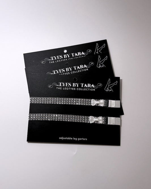 Vixen Sparkly Bow Leg Garters displayed on black retail cards in a 3 pack 