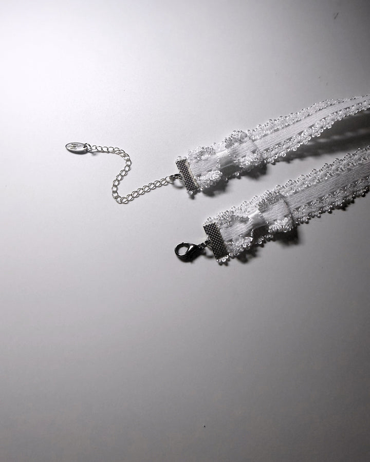 Lady White Elastic Bow Choker showing bows and extender chain
