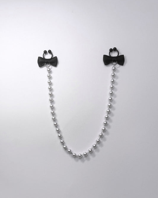 Centerfold Pearl Nipple Clamps with black bows and a creamy pearl strand connecting them