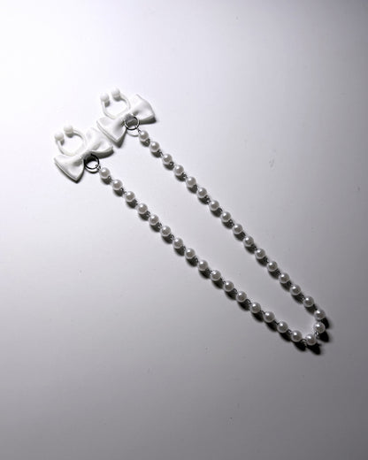 View two of the pearl nipple clamps with white bows 