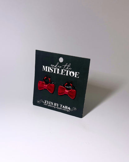 red velvet bow nipple clamps on black card