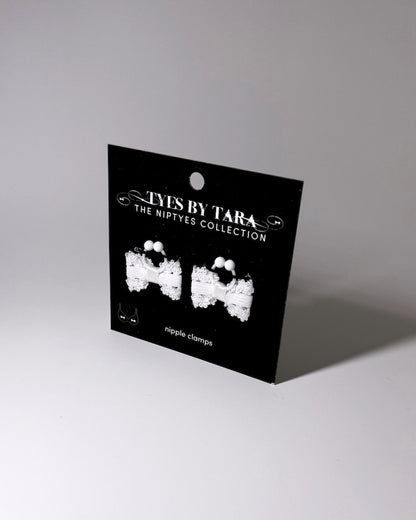 Lady White bow nipple clamps displayed on a retail black card