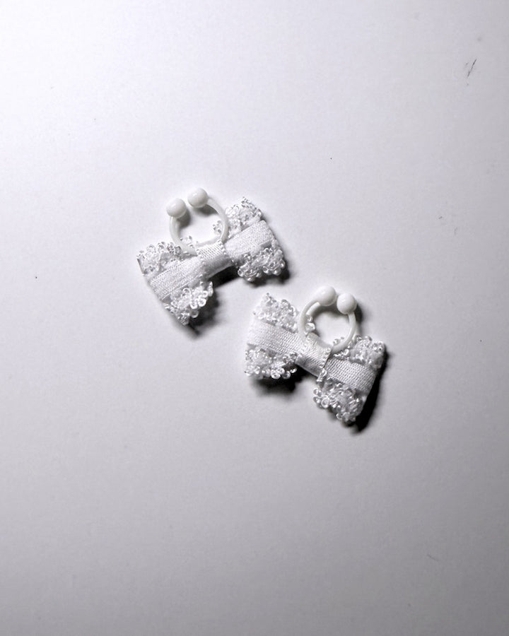 Lady White bow nipple clamps jewelry on soft gray background