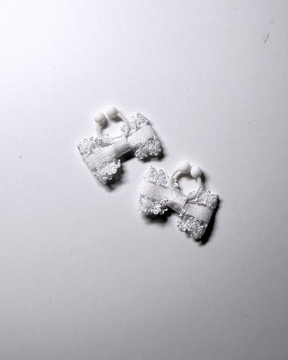 Lady White bow nipple clamps jewelry on soft gray background