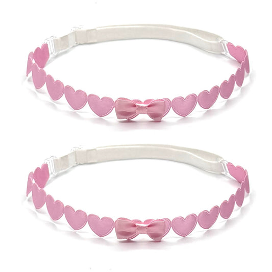 Two pink leg garters with heart and bow designs on a white background