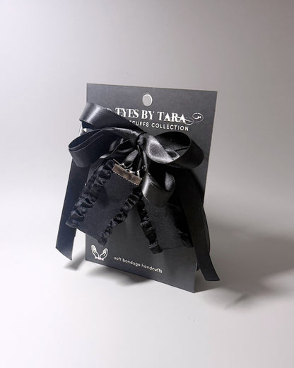 Black Ruffled Handcuffs with long satin ties on black card