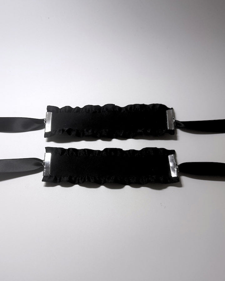 Black Ruffled Handcuffs with long satin ties flatlay view