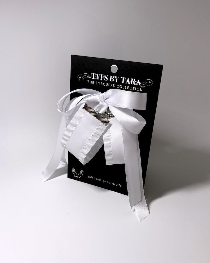White Ruffled Bow Handcuffs on the Black Card