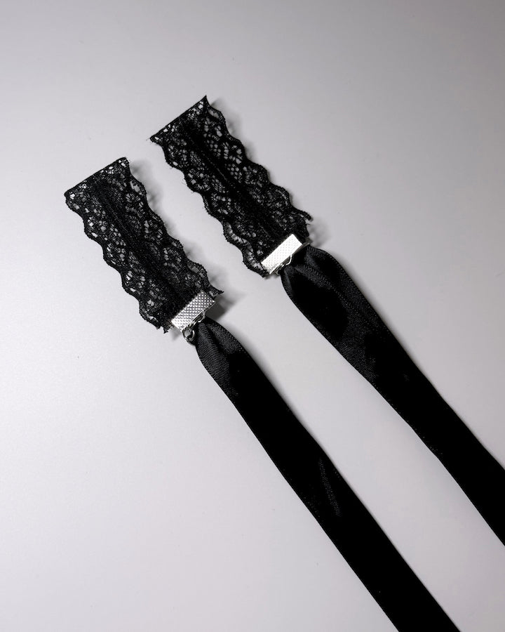 Siren Black Lace Handcuffs showing cuffs folded with long satin ties